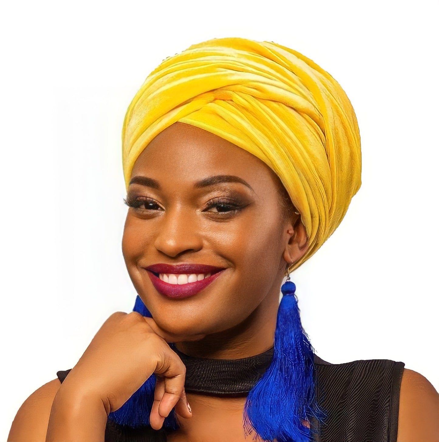 Lady smiling with yellow scarf and blue earrings