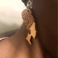 Black woman wearing earrings showing right side