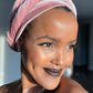 Woman with dusty pink turban taking a selfie
